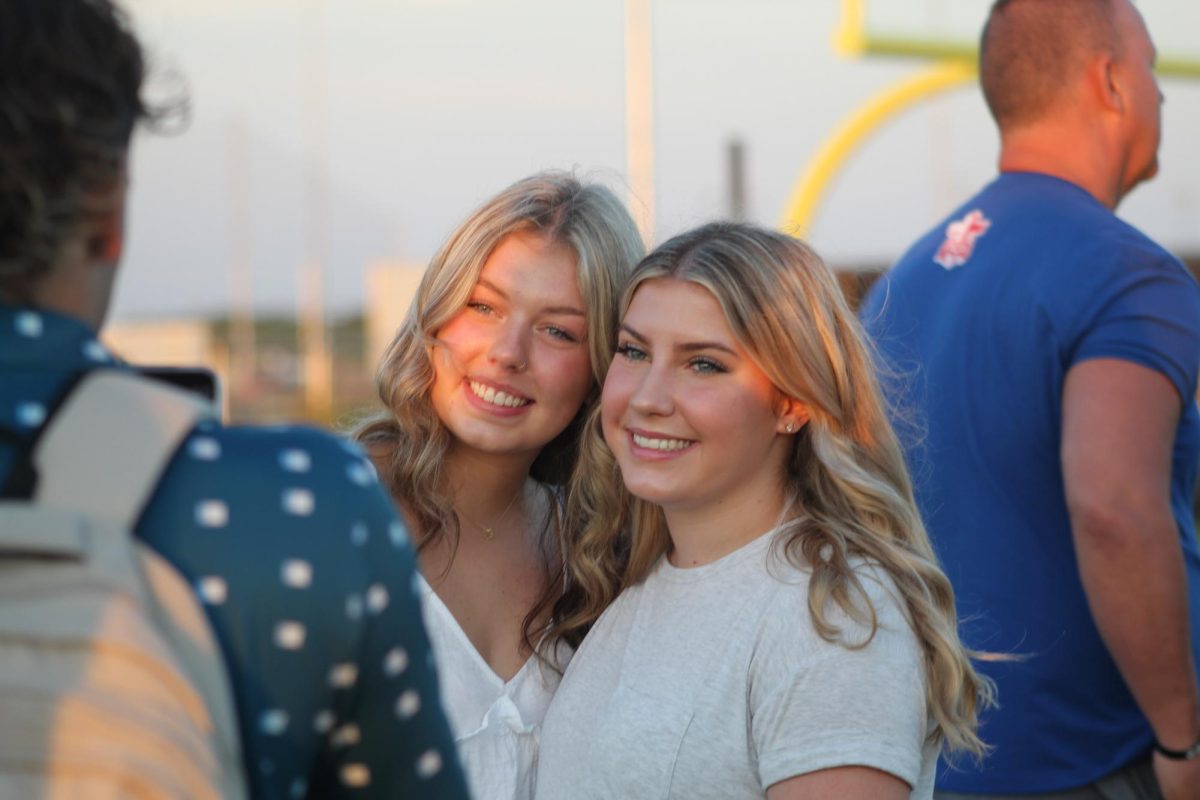 Addison Ermis and Carly Whitmire enjoy Senior Sunrise on the Memorial High School turf last Thursday. 