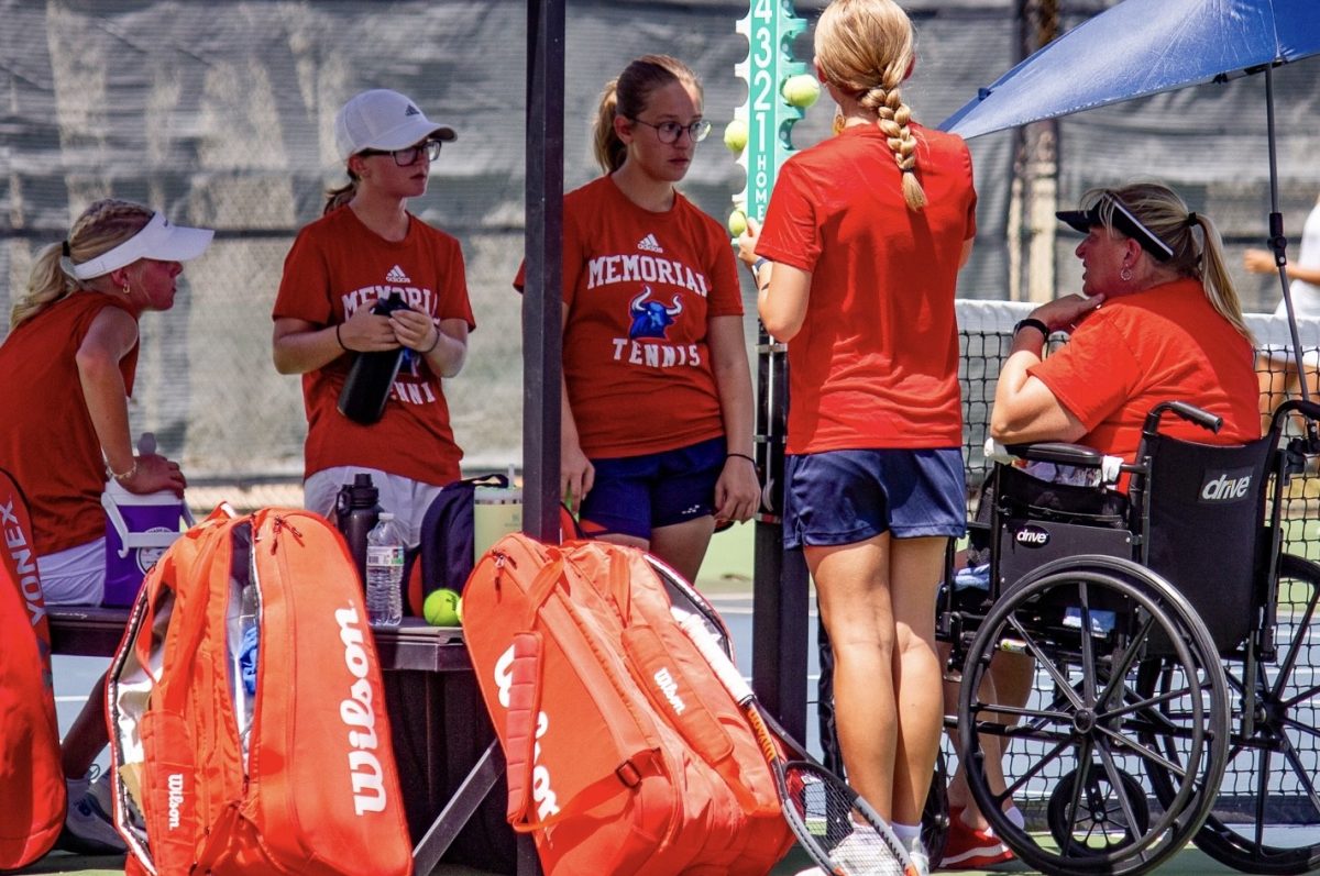 Memorial tennis coach Kim Walding talks to some of the girls during the Mavericks' first match on Aug. 1. against Amarillo Tascosa. 