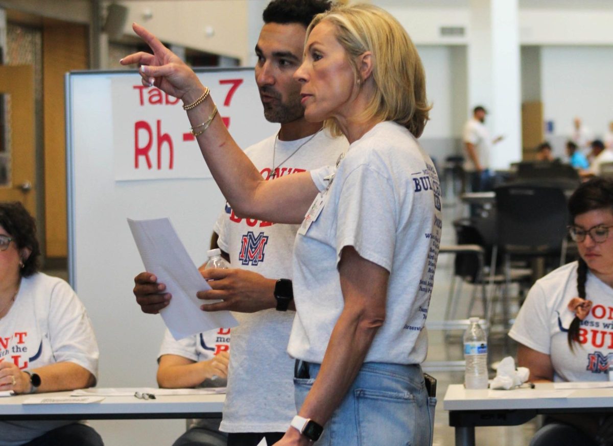 Memorial principal Laurie Kinne talks with staff member Ryan Quezada at Bull School. 