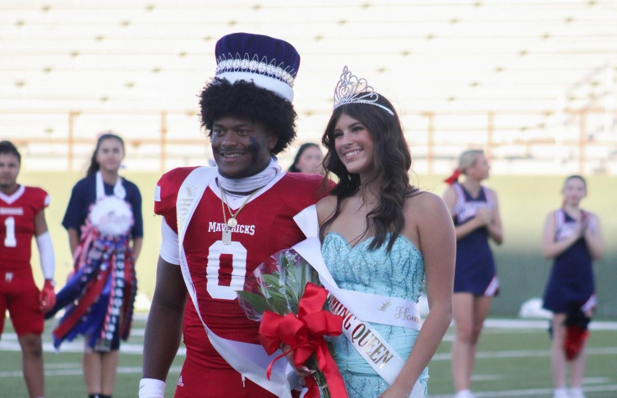 Memorial Homecoming king Kenji Johnson and queen Lizzy Diaz pose for a picture before Friday's football game. 