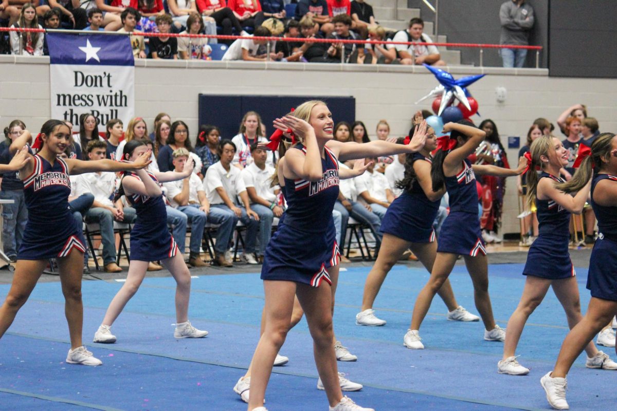 Carol Anne Happney-White and the Memorial cheerleaders perform during a September pep rally. 