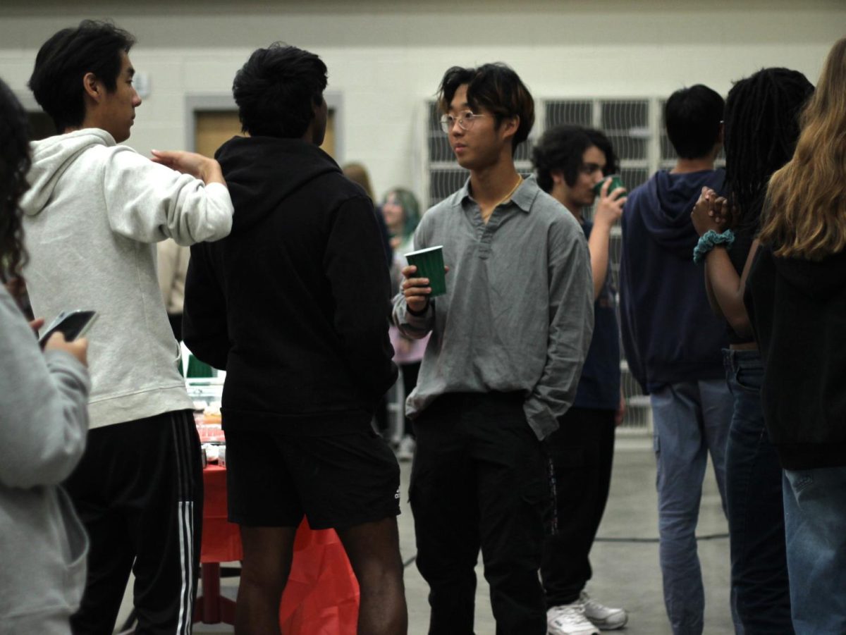 Jun Park talks with Memorial students at a party honoring his first chair all-state honor. 