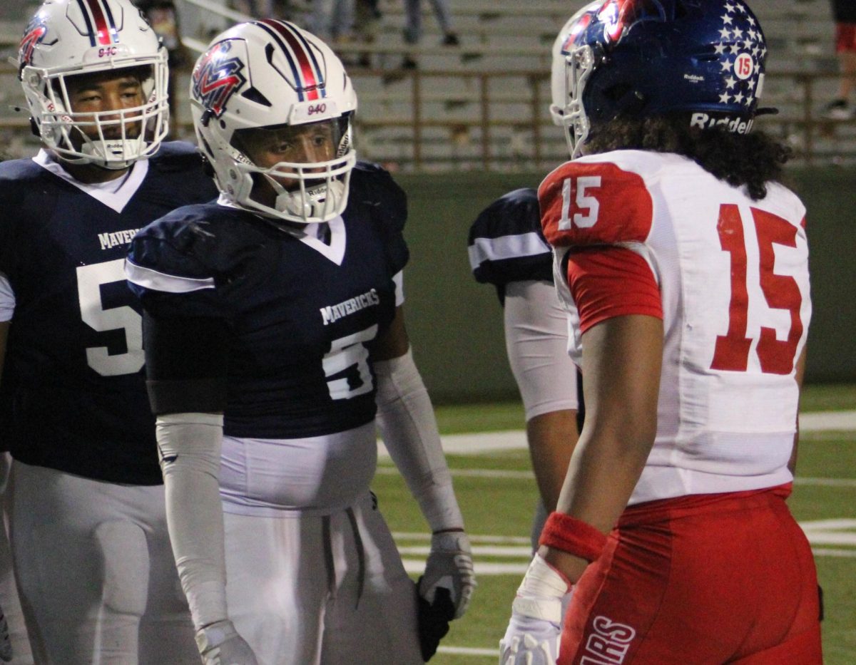 Josiah Grant shakes hands with an Abilene Cooper player after a September home game. 