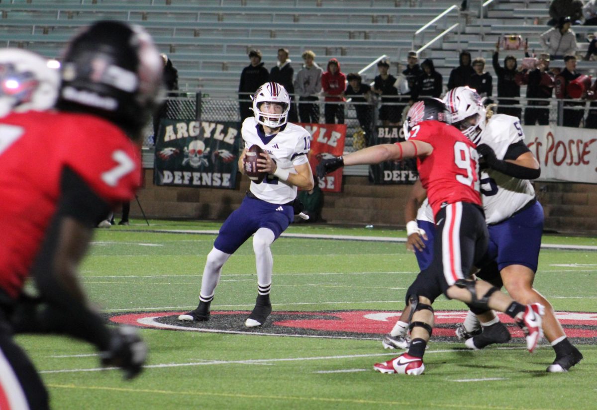 Joe Castles drops back to pass in a recent 28-21 playoff loss to No. 4 Argyle. Castles and the Mavericks finished their first season with a 9-3 record.