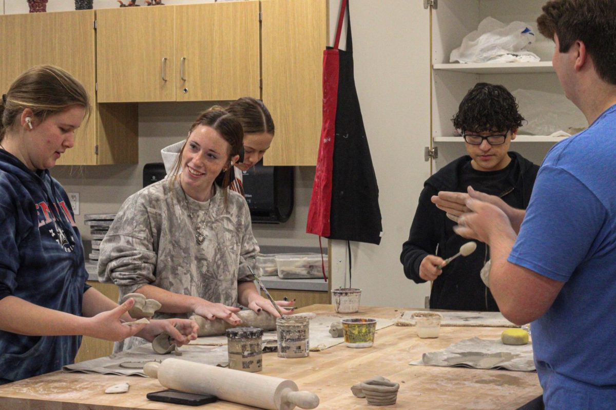 Madison Dishman and Kadyn Timmons work on a ceramics project during their art class. 