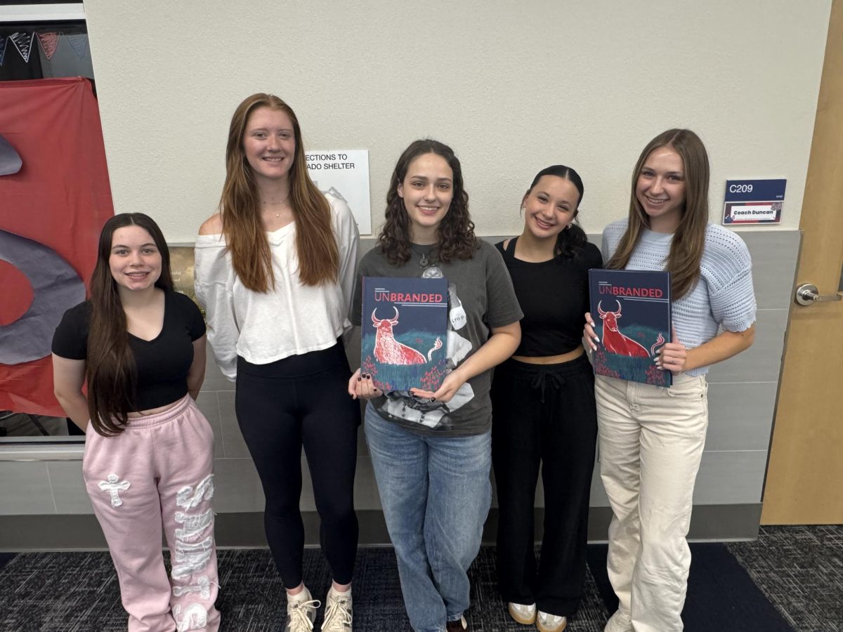 Yearbook editors Marissa Guerrero, Carsyn Wise, Hannah Martin, Kensley Almanza and Madi Smith hold copies of the 2025 Maverick yearbook. 