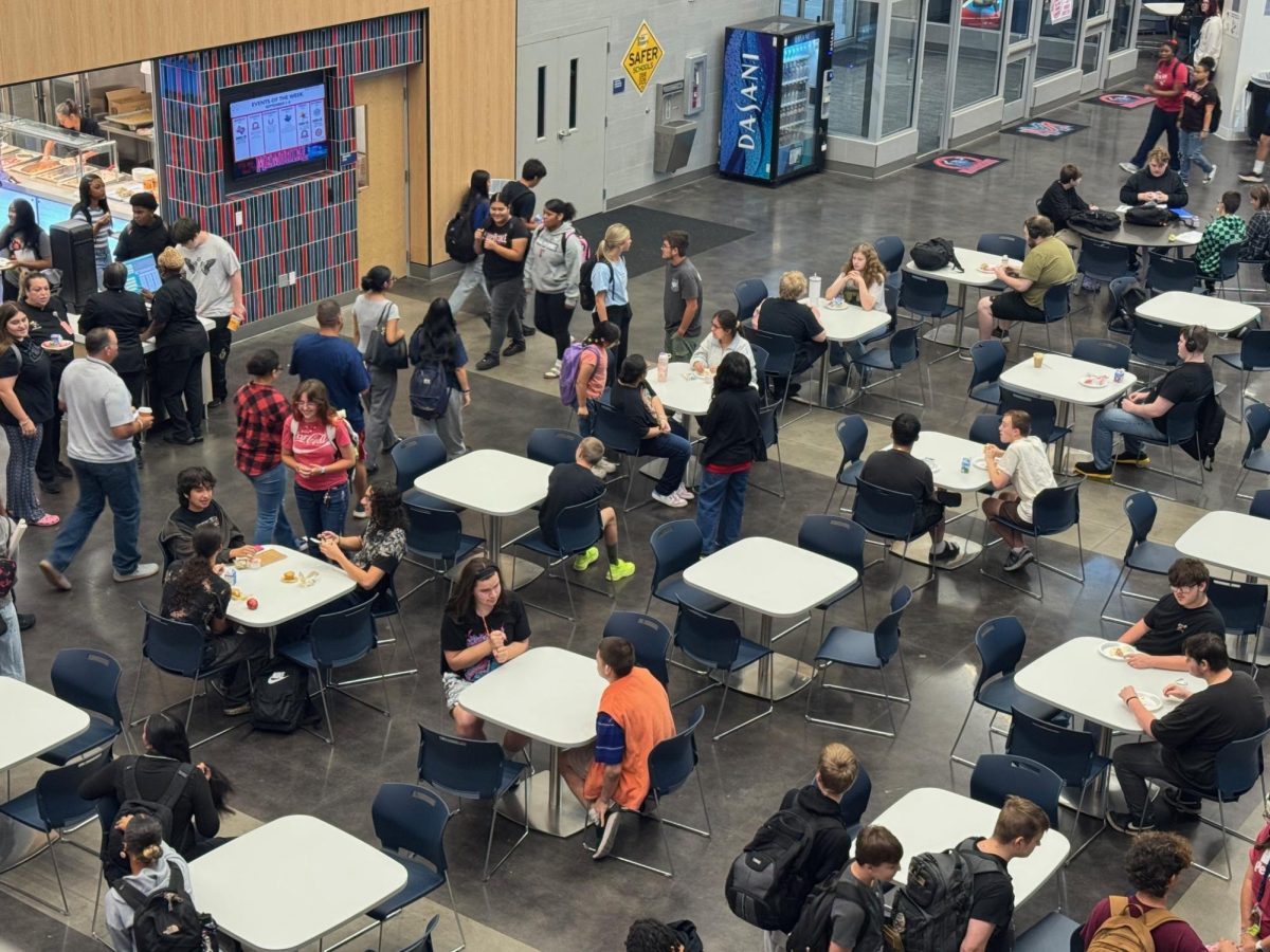 Before school starts, Memorial students begin their day in the cafeteria. The only difference this year is they can't be on their phones now. 